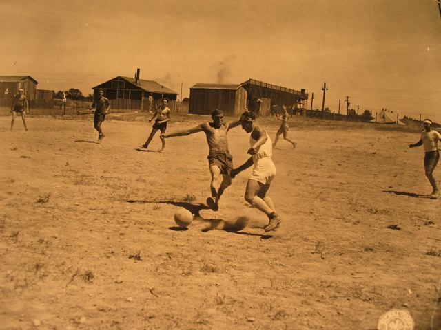 Photo of German prisoners of war, at a sidecamp in Michigan, are pictured here playing soccer; their chief form of outdoor recreation." 8-8-44 Photographer Sgt. A.L. Hertel
