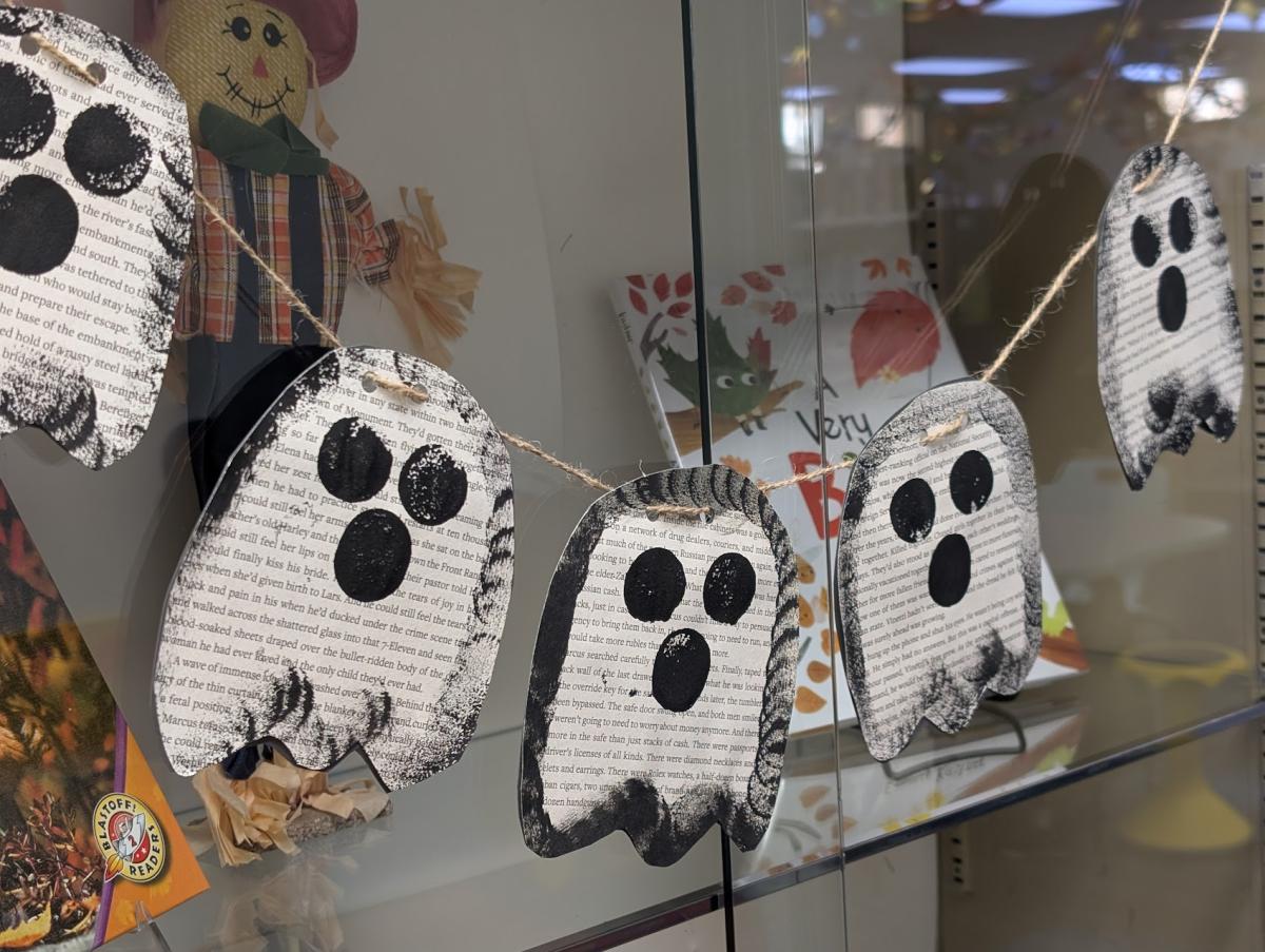 photo of ghost garland made from book pages and black paint